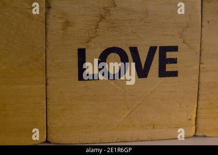 word love written on a wooden cube in black Stock Photo
