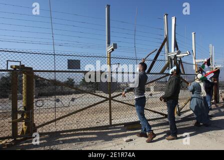 Qalqilya, West Bank city of Qalqilya. 9th Jan, 2021. Palestinian protesters gather at the gate of a fence, part of the Israeli barrier, during a protest against the expansion of Jewish settlements, in Kafr Thulth, east of the West Bank city of Qalqilya, Jan. 9, 2021. Credit: Nidal Eshtayeh/Xinhua/Alamy Live News Stock Photo