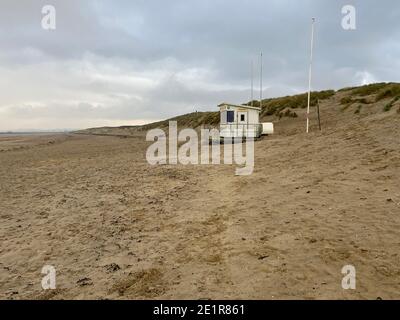 camber sands beach in Camber village East Sussex UK in winter, popular day tripper destination in summer on South England coast lifeguard tower Stock Photo