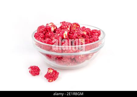 Red caramel popcorn in a transparent glass bowl on a white background Stock Photo