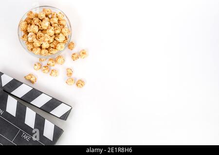 Movie clapperboard with popcorn on a white background with copy space. For articles about the film. Stock Photo