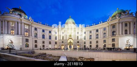 Panorama of the Spanish Riding School in the Hofburg at Michaelerplatz in Vienna, Austria at night. Stock Photo