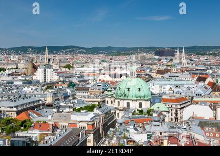 St. Peter's Church (Peterskirche) coppola in Vienna, Austria with blue sky and the Votivkirche in the background. Stock Photo