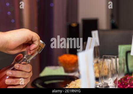 Close up view of male hands opening bottle of wine. Holidays. Alcohol. Stock Photo