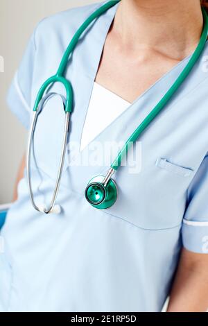 Beautiful young nurse woman wearing uniform and stethoscope at the ...