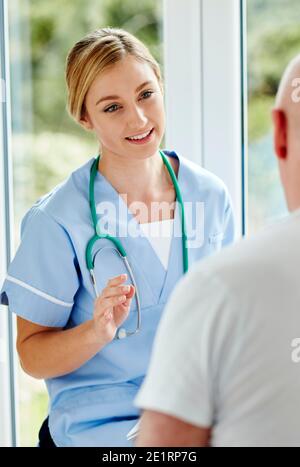 Nurse talking to patient Stock Photo