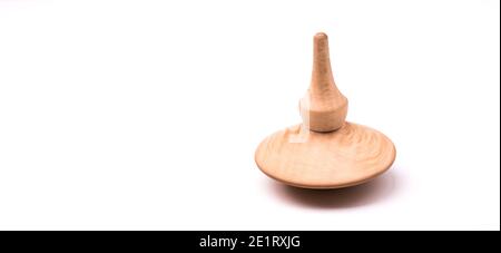 Close up shot of a wooden spinning top moving on white background, isolated Stock Photo