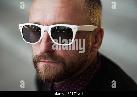 Bearded man portrait. Guy bearded in sunglasses. Close up of handsome bearded man sunglasses Stock Photo