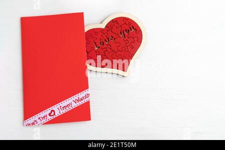 Envelope and heart assembled from puzzles on a white background with space for text.. Stock Photo