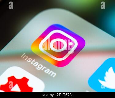 Instagram app icon on Apple iPhone screen. Instagram is a photo and video sharing social networking service owned by Facebook. Stock Photo