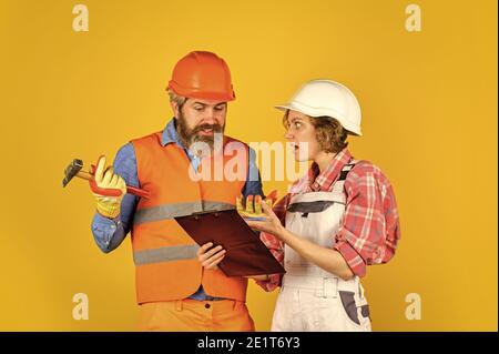confident electrical and technician. engineers couple working together on building blueprint. work at construction site or factory. Civil engineering. industrial business partner. job and occupation. Stock Photo