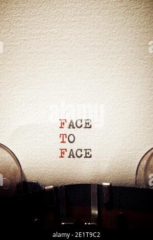 Face to face phrase written with a typewriter. Stock Photo