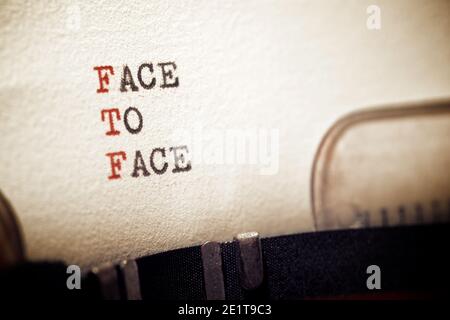 Face to face phrase written with a typewriter. Stock Photo