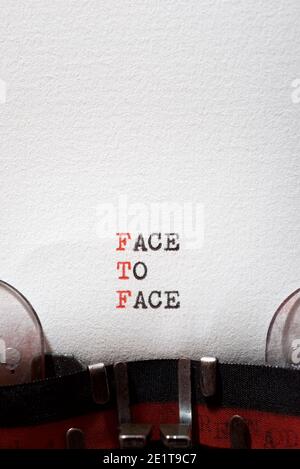 Face to face phrase written with a typewriter. Stock Photo