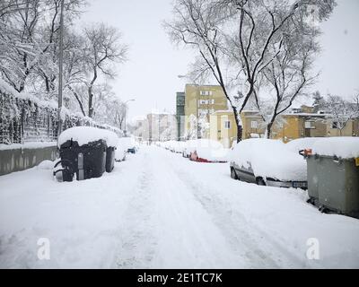 Madrid, Spain. January 09, 2021: Snowstorm, blizzard on streets, cars covered. Snowing in winter. Stock Photo