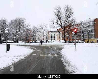 Madrid, Spain. January 09, 2021: Snowstorm, blizzard on streets, cars covered. Snowing in winter. Stock Photo