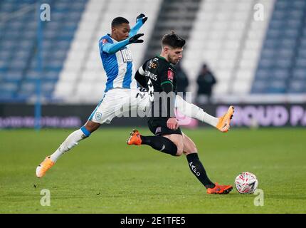 Huddersfield Town's Jaden Brown (left) and Plymouth Argyle's Joe Edwards battle for the ball during the Emirates FA Cup third round match at John Smith's Stadium, Huddersfield. Stock Photo