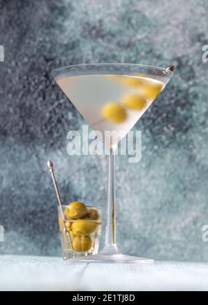 Glass of Dry Martini with green olives Stock Photo