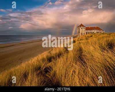 Rainbow at dramatic sky at the beach Stock Photo