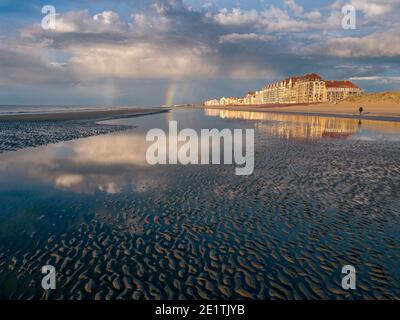 Beachfront with dramatic sky and rainbow Stock Photo