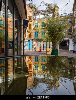 Colourful shops are reflected in Neal's Yard, Covent Garden during the pandemic lockdown in London. Stock Photo