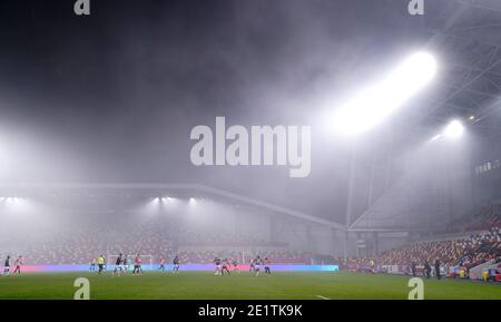 General view of the action between Brentford and Middlesbrough in foggy conditions, during the Emirates FA Cup third round match at the Brentford Community Stadium, London. Stock Photo