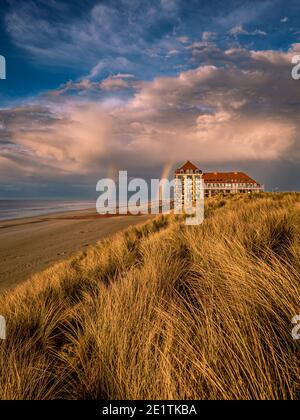 Two rainbows in dramatic sky at the beach Stock Photo