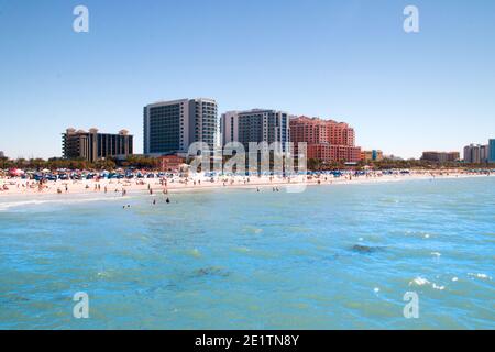 Tropical sandy beach crowded by sunbathing tourists in Clearwater Beach, Tampa Bay, Florida vacation, USA Stock Photo