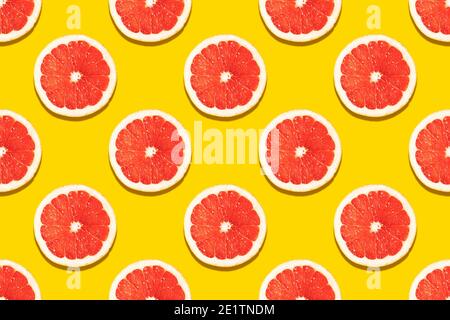 Seamless pattern with a slice of grapefruit on a yellow background. Drawing for decoration, packaging, banner. Stock Photo
