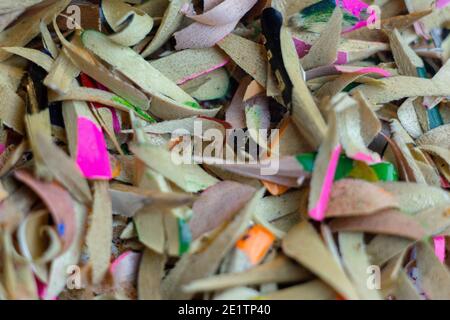 Shavings of colored pencils on a white background. Macro shooting. Stock Photo