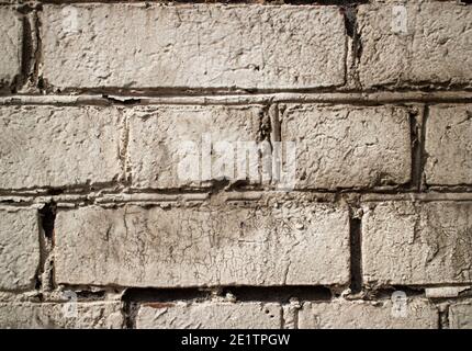 Close-up. Old white brick wall. Texture. Screensaver on your desktop. Photo wallpaper. Stock Photo