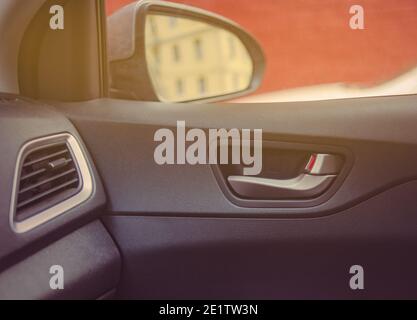 car interrior details with side mirror and door handle visible Stock Photo