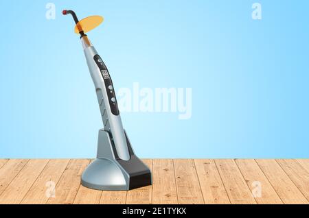 Wireless dental curing light LED on the wooden planks, 3D rendering Stock Photo