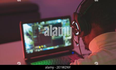 Black man using laptop late at night. Connection through social media during lockdown. High quality photo Stock Photo
