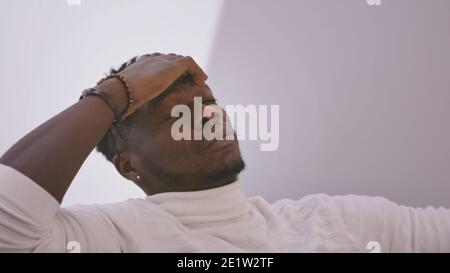 Bored black falling asleep on the couch. High quality photo Stock Photo