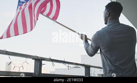 Young attractive black man waving American flag. High quality photo Stock Photo
