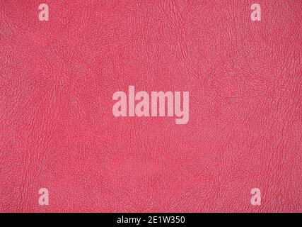 Genuine leather with large folds, artificially dyed in red. Background, texture. Stock Photo