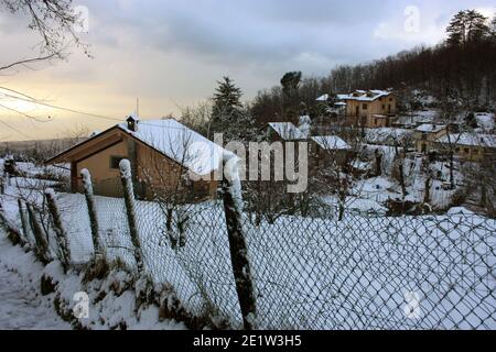 lonely modern cabin in the mountain peak among the white winter snow in tuscany Stock Photo