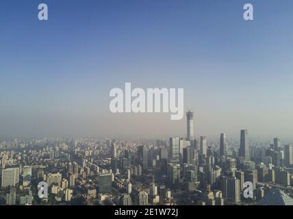 Aerial view of the city skyline with buildings and high rises on a day with light smog in the Dongcheng and Chaoyang district of the Chinese capital city of Beijing, China, PRC. © Time-Snaps Stock Photo