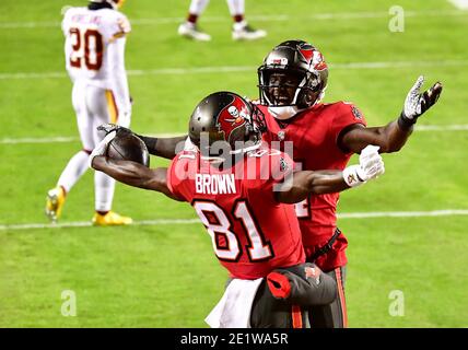 Landover, United States. 09th Jan, 2021. Tampa Bay Buccaneers wide receiver  Antonio Brown (81) celebrates with teammate Chris Godwin (R) after a  36-yard touchdown against the Washington Football Team during the first