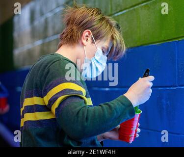 Al Eburne of Bellefonte helps to repaint a mural vandalized with white nationalist graffiti.Dozens of community members gathered at Jake's Cards and Games to repaint the defaced pride mural on the side of the business. Volunteers took turns painting over the spray painted messages from the white nationalist group Patriot Front. Stock Photo