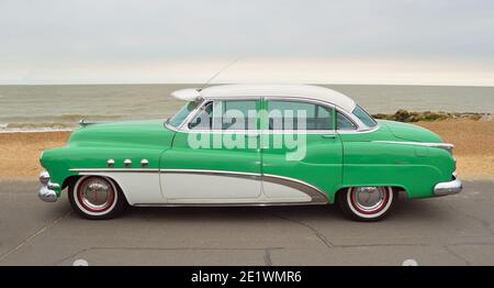 Classic Green and White Buick Super Eight Moto Car parked on seafront promenade. Stock Photo