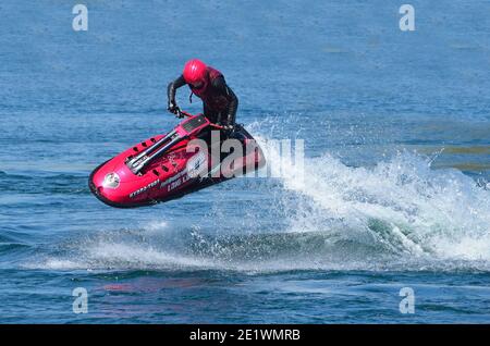 Freestyle Jet Skier performing 360  creating at lot of spray. Stock Photo