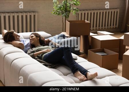 Smiling man and woman relax on moving day Stock Photo