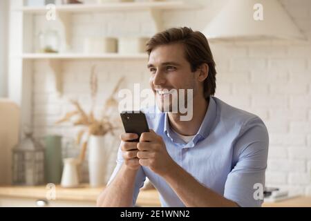 Happy young man use smartphone browsing internet Stock Photo