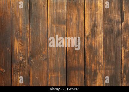 Texture of old, brown wood boards. Charred and burnt old Board with knots close up. Stock Photo