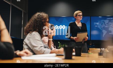 business woman talking with team during a meeting. business professionals having meeting in office board room. Stock Photo