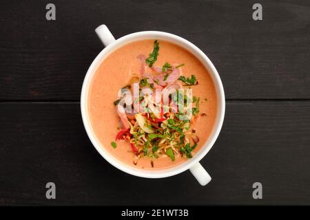 Top view of vegetable cream soup with shrimps on wooden background Stock Photo