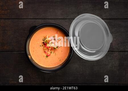 Top view of vegetable cream soup with shrimps in take away packaging Stock Photo
