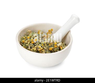 Mortar with dried herbs on white background Stock Photo